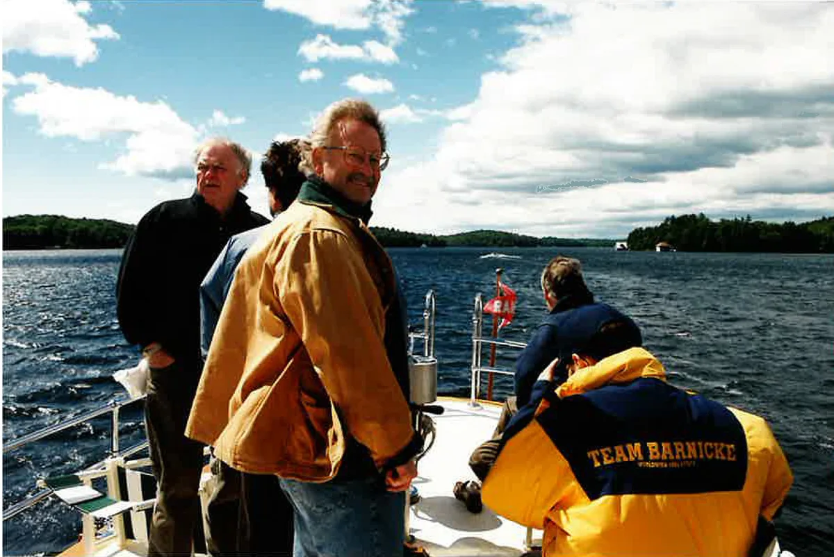 Colleagues aboard a boat on the lake during a company retreat