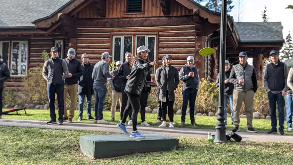 A team member throwing a disc during a company retreat game